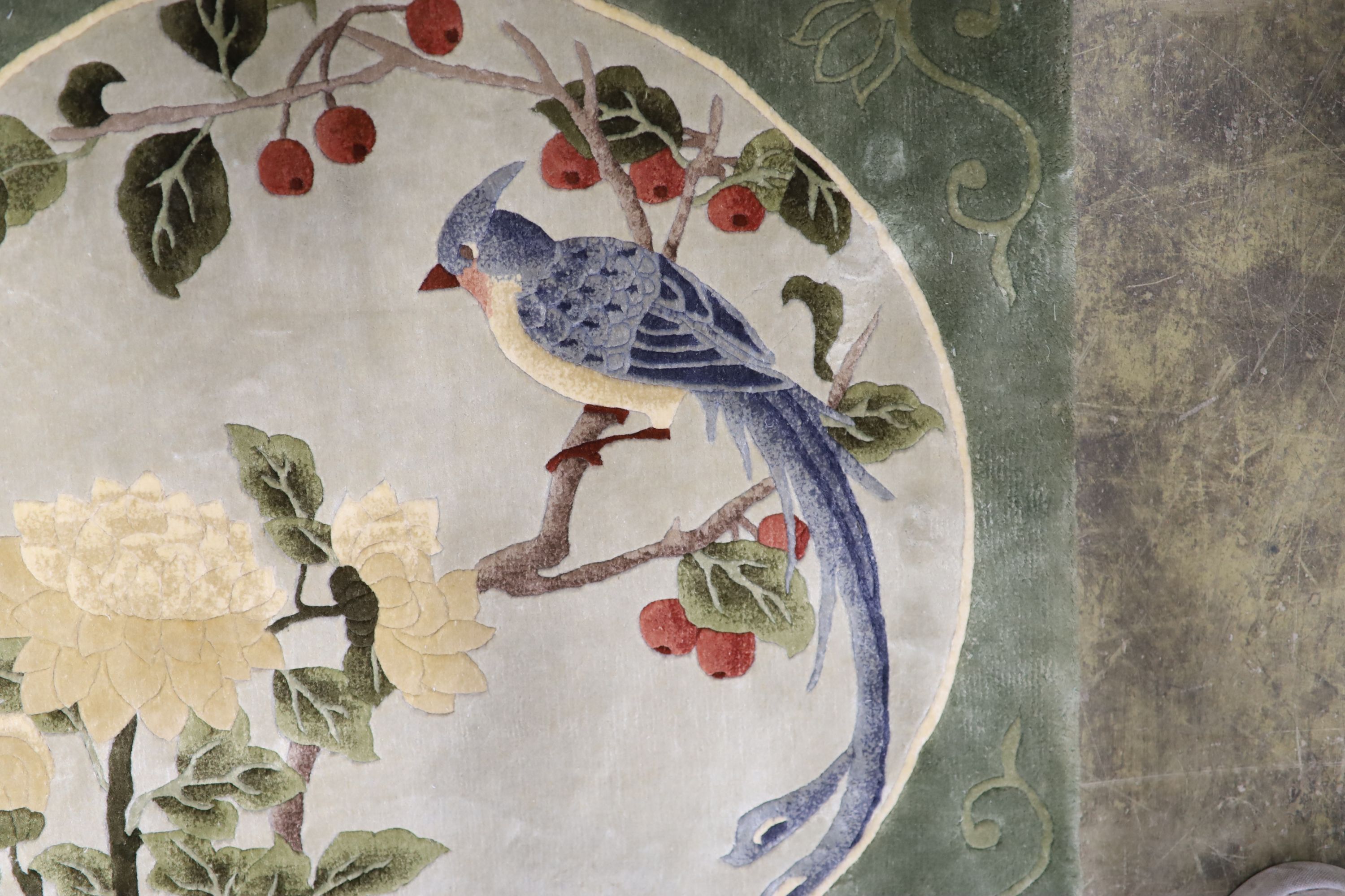 A Chinese washed and embossed panel depicting birds amongst prunus and cherries